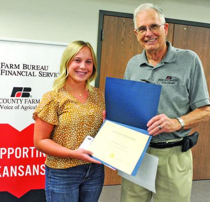 Brooke Beck, pictured with presenter Tom Norris, received this year’s Helen NOrris Memorial Scholarship at the Sumner County Farm Bureua Awards. Dale Stelz/TSnews