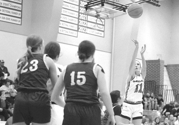 Sadie Koester shoots from behind the 3-point arc during Conway Springs’ home win over Medicine Lodge last Friday, giving new head coach Andrew Gower a victory in his first game with the Cardinals. Stephanie McKennon/TSnews