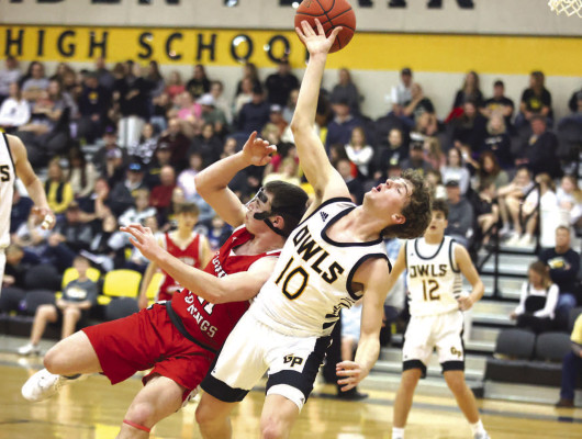 Conway Springs’ Connor Rusco, left, and Garden Plain’s Seth Dugan both fall to the floor while battling for a rebound during Friday’s Central Plains League game on the Owls’ home court. The Cardinals were victorious. Stephanie McKennon/TSnews