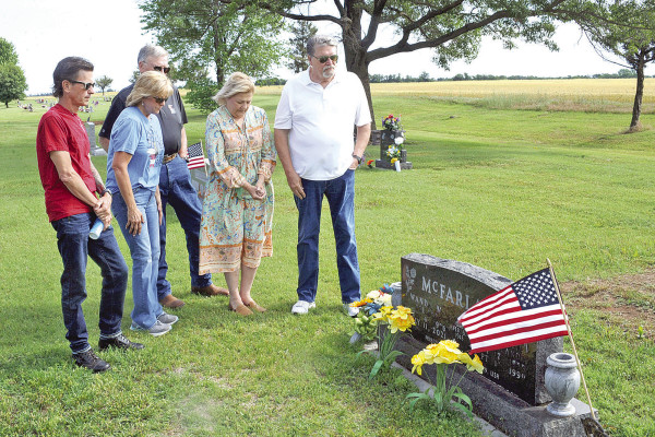 Photo by Dale Stelz/TSnews Family members pay their respects to Wanda and Ervin McFarland on Monday at the Argonia Cemetery. Memorial Day services were held at a number of area cemeteries on Monday morning, with attendees paying their respects to military members who lost their lives while serving. Many people also use the holiday to remember family members and friends who have died.