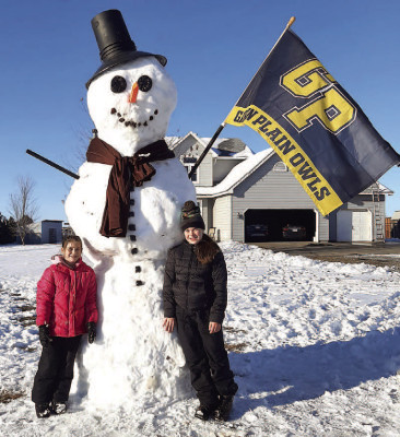 McKynlie and Addyson Benn show of their giant snowman as well as their Garden Plain pride. Contributed photo
