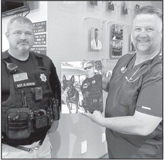 On April 6, the Haysville Police Department presented Dr. Robert Prichard with a plaque, expressing thanks for exceptiona; care provided to past and present K-9 units in Haysville and around Sedgwick County. HPD staff presented Prichard with a photograph of Sgt. Randy Nowak with past K-9 officer Rox. Prichard also was presented a challenge coin. Prichard owns and operates Prichard Animal Hospital in Haysville. Contributed photo