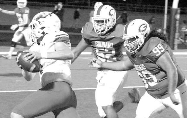 Goddard’s Lukas Bishop (52) and Pablo Martinez (99) chase down a Maize ball carrier during last Thursday’s playoff game in Goddard. Travis Mounts/Tsnews