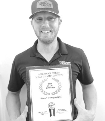 James Gaida shows off Stroot Lockers’ 2023 grand champion award for bacon at the American Cured Meat Championship. Contributed photo
