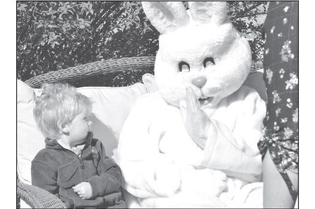 The Easter Bunny tries to give 2-yearold Dawson Walker a “high five” at the Garden Plain Easter egg hunt on Saturday. Paul Rhodes/TSNews