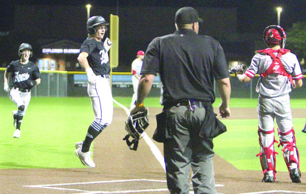 Eisenhower’s Aaron Dimit jumps in the air as he comes home to score during the Tigers’ 4-run outburst in the bottom of the sixth inning. That inning broke a 4-all tie and helped Eisenhower beat the Maize Eagles in last Wednesday’s Class 5A regional championship, hosted by the Tigers. Travis Mounts/TSnews