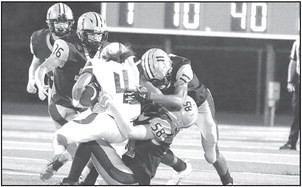 Clearwater defenders gang tackle a Collegiate ball carrier during Friday’s homecoming football game. Jessica Reed/ TSnews