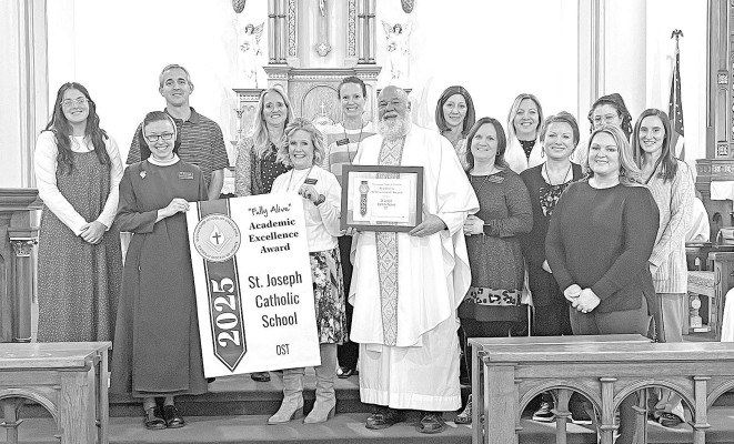 St. Joseph Catholic School principal Liz Charles and Father Bernard Gorges, front center, are joined by the St. Joe Ost staff as they are presented with the 2025 Diocesan District Award for Academic Achievement. Contributed photo