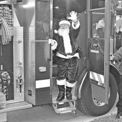 Santa Claus arrives via a red sleigh (fire truck) at Haysville Pride Park for the Christmas tree lighting at Saturday's Village Christmas. The event included visits with Santa Claus, live music, wagon rides and train rides, food, and familyfriendly