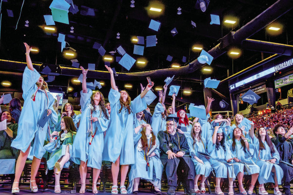 ABOVE: Eisenhower High School students celebrate their graduation last Saturday at Heritage Credit Union Arena in Park City. The district held three graduation ceremonies last week, and Clearwater High School held its graduation. BELOW LEFT: Clearwater High graduate Hope Martin shows off her diploma at Sunday’s commencement. BELOW RIGHT: Goddard High graduate Isabel Zapata hugs principal Doug Bridwell at Goddard High’s graduation on Saturday. Photos by Goddard USD 265 and by Stephanie McKennon