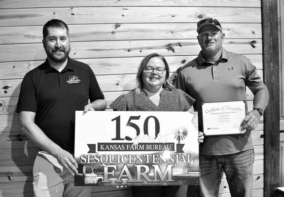 Andrew and Shevell Bowman receive their Sesquicentenntial Farm award in Sedgwick County, which recognizes a farm as being in the same family for at least 150 years. Dale Stelz/TSnews