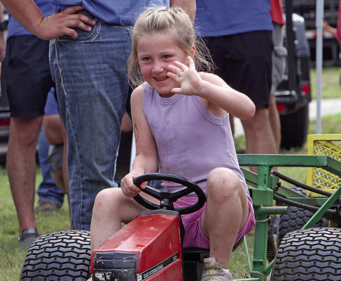 Lucy Lehner gives a wave while participating in Saturday morning’s pedal pull at the Sedgwick County Fair. The Fair took place July 8-11, drawing in thousands of people from many communities. See more photographs from the Fair on Page B1. Travis Mounts/TSnews