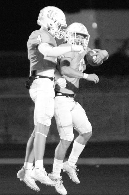 Carter Pabst, left, and Lucas Dickman celebrate Dickman’s touchdown early in the second quarter. He scored twice in the second quarter as the Eisenhower Tigers overcame an early deficit to beat Andover in last Friday’s playoff game in Goddard. Travis Mounts/Tsnews