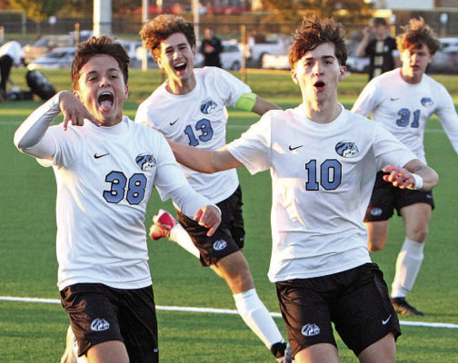 Kellen Christians celebrates with teammates after scoring to give the Eisenhower Tigers a 1-0 lead at Maize South at last Thursday’s Class 5A regional soccer championship. Travis Mounts/TSnews