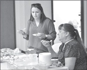 Claire Coleman, left, field services manager for Kansas Farm Bureau, and local member Marsha Weishaar, were in charge of tasting desserts at the annual Sumner County Farm Bureau Association meeting, held recently in Wellington. Desserts were provided by local 4-H clubs. Awards went to the Cardinals for appearance, the Red Wings for flavor, the 4-H Council for number of servings, and Happy Hustlers for consistency. Paul Rhodes/TSnews
