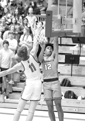 Brayden Bergkamp of Clearwater puts up a first-half shot as Cheney’s Colton Summerer defends him during last Friday’s season-opening games for both teams. A strong second quarter helped the Cardinals defeat the Indians. Stephanie McKennon/TSnews
