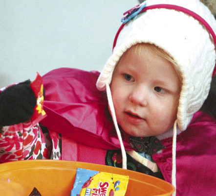 Tessa Hageman pulls a package of candy out of a bowl during Monday night’s Halloween event in downtown Conway Springs. Many youngsters and their families came out for the trick-or-treat event. See more photographs on Page A10. Travis Mounts/TSnews