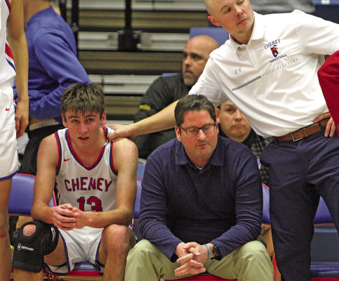 Cheney Cardinals assistant coach Chad Harbour-Nordahl, a former Cheney player, puts his hand on the shoulder of Jase Robertson after Robertson came to the bench following a foul. The Cardinals lost to the Goodland Cowboys, a team that has placed second at State the past two seasons. Travis Mounts/TSnews
