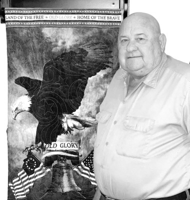Gary Parks of Argonia stands by the quilt that he received from the local Quilts of Valor group. Parks was drafted just weeks after being married. He served in the United States ARmy for four years, and spent nearly two years in Vietnam. Travis Mounts/TSnews