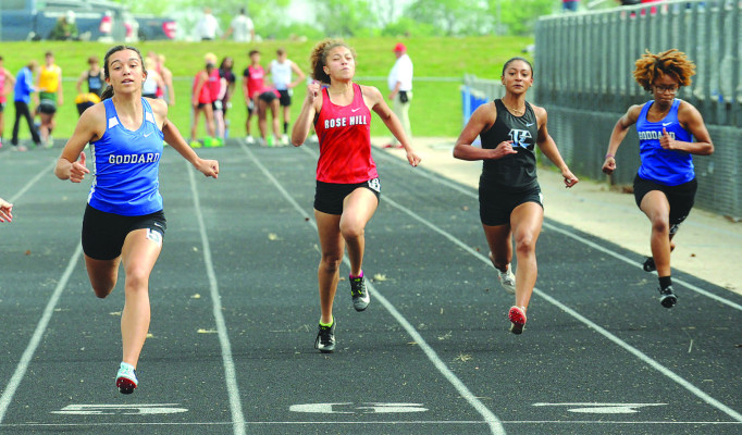 Goddard runners Leah LaPlant, left, and Monty Ray, right, and Eisenhower runner Julissa Lawrence, second from right, reach the finish line during a preliminary head of the 100 meters during Goddard’s home track and field meet. It was held last Thursday. Subscribers can see additional photos online at www.tsnews.com. Dale Stelz/TSnews