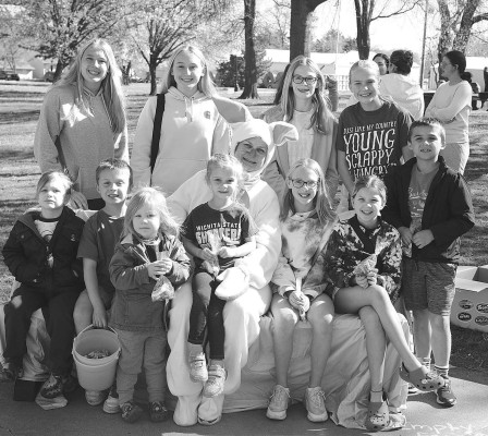 Members of the Bartonek, Erker and Tyler families collect around the Easter Bunny. Dale Stelz/TSnews