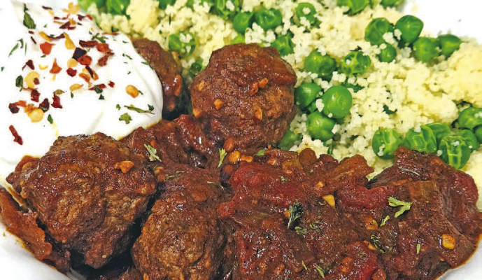 Moroccan lamb meatballs are made with an earthy, spicy mix of herbs and spices and served doused in a delicious tomato sauce that pairs perfectly with couscous and some plain Greek yogurt on the side.