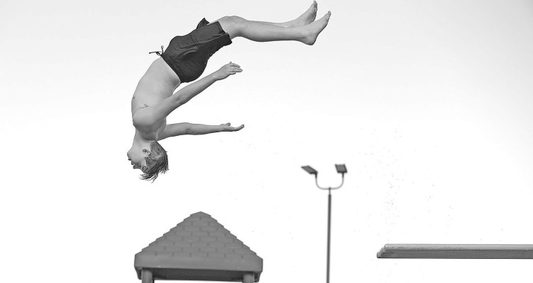 Mason Wooden does a back dive off the high dive at the Dewey Gunzelman Swimming Pool, site of last week's National Night Out celebration in Haysville. The pool offered free admission, and City of Haysville employees prepared and served a picnic dinner. The event was held on Tuesday, Aug. 1. Subscribers can see a larger photo gallery online at tsnews.com. Stephanie McKennon/TSnews