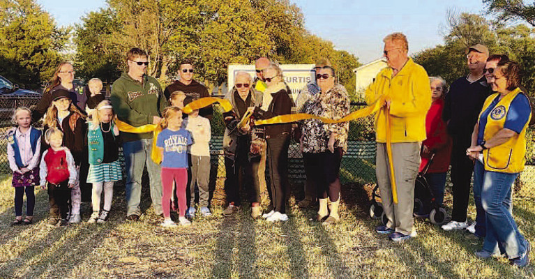 David Curtis cuts the ribbon at the recent rededication of the David A. Curtis Goddard Community Garden. Contributed photo