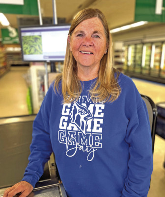 Kathy Pauly stands at one of the registers at SPK Grocery, where she has been a familiar and friendly face to shoppers for 35 years. Pauly is retiring as December ends. Travis Mounts/TSmews