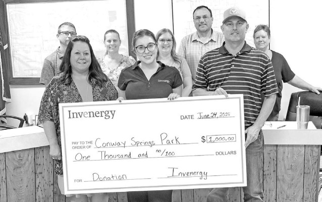 Members of Invenergy, a company that is doing work in the area, present members of the Conway Springs City Council with a $1,000 donation for park improvements. The check was presented at last week's city council meeting. Paul Rhodes/TSnews