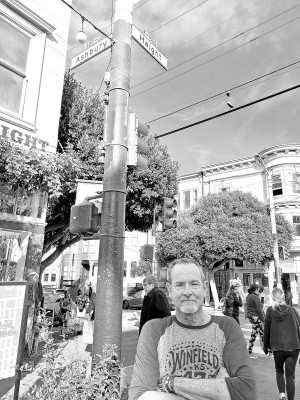 Publisher Paul Rhodes gets his picture taken at the intersection of Haight and Ashbury streets in San Francisco. Kim Swansen/TSnews