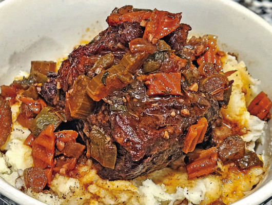 Braised short ribs are seared to perfection before being slow cooked in the oven with lots of vegetables and seasonings, along with wine and beef stock, to create a rich sauce.