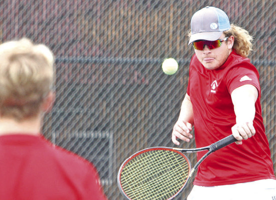 ABOVE: Conway Springs doubles player Brayden Stevens hits a return during Thursday’s home action. 