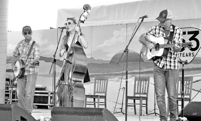 80 Proof Alice, with members Tyson Lesage on guitar, Jason Riegel on banjo and Aimee Riegel on bass, perform at the 53rd Walnut Valley Festival in September. Kim Swansen/TSnews
