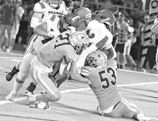 Clearwater defenders Lane Blevins (21) and Braeden Gordon (53) team up to tackle a Wellington ball carrier during last Friday’s home game. Travis Mounts/TSnews
