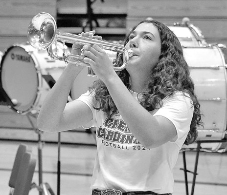 RIGHT: Veterans listen to fellow veteran Cheney Mayor Phil Mize speak during last Friday’s Veterans Day program, hosted by Cheney High School and Cheney Middle School. The program took place in the high school auditorium, and included a reception for veterans after the program. ABOVE: Breanna Wells plays “Taps” during Friday’s Veterans Day ceremony. Dale Stelz/TSnews