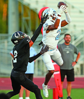 Braylon Lies makes a catch for the Eisenhower Tigers during their come-frombehind win over Campus in Haysville. The Colts’ Emauni Buncome defends Lies. Matt Bucher/Ginger Viking Fotos
