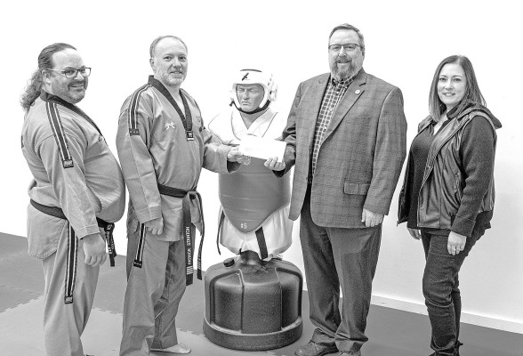 Pictured from left are Chris Kurtz, master instructor and co-owner of Black Eagle Martial Arts; Patrick Stanton, master instructor and co-owner; Haysville Mayor Russ Kessler; and Danielle Gabor, economic development director for the City of Haysville. Not pictured is Tim Hendricks of Hendricks Properties, LLC. Contributed photo/City of Haysville