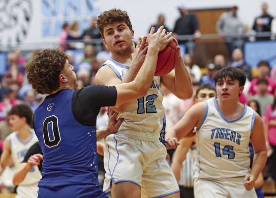 Goddard’s Erik Olivas (0) tries to strip the ball from Eisenhower’s Brayden Pappas during last week’s homecoming game at EHS. The Tigers beat the Lions. Matt Buchar/Ginger Viking Fotos