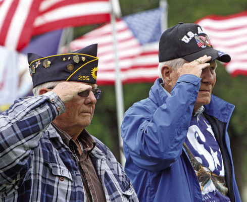 Cheney veterans Les Shepherd, left, and Dave Black salute during the playing of “Taps” at Monday’s Memorial Day service at Fairview Cemetery. Similar events were held in Argonia, Clearwater, Conway Springs, Viola and near Haysville. See photos from some of the ceremonies on Page B8. Travis Mounts/TSnews