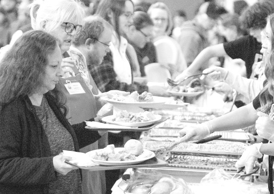 Many people and groups came together last Thursday for the annual Goddard Community Thanksgiving Dinner, which was held at The Goddard Church. This year's event drew a record 415 diners, including to-go diners. The Goddard Lions Club coordinated the event, and the Goddard Woman's Club made and served dessert. Students from Eisenhower Middle School handle much of the serving. Subscribers can see more photos online at tsnews.com. Travis Mounts/TSnews