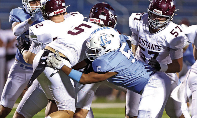 Eisenhower’s Andre Robinson, Jr., makes a tackle against a Salina Central runner. The Tigers came out of a long delay recharged, and came from behind to take down the defending Class 5A State champions. Matt Bucher/Ginger Viking Fotos