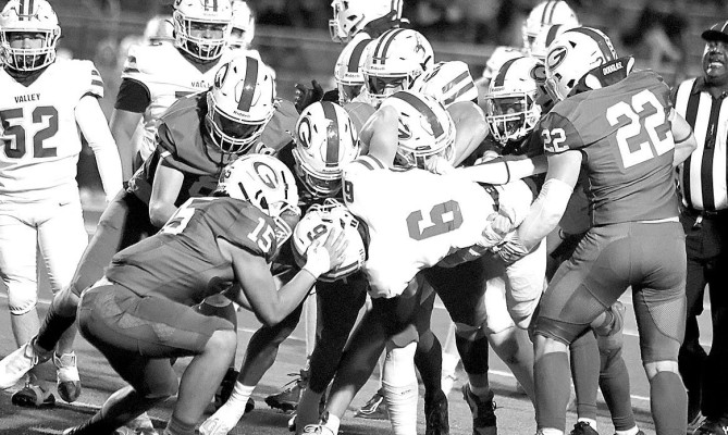 Lions’ defenders team up to take down a Valley Center player during last Friday’s home playoff game. Stephanie McKennon/ TSnews