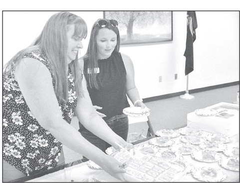 Marsha Weishaar and Claire Coleman serve up desserts that were prepared for the Sumner County Farm Bureau Annual Meeting held recently at the Raymond Frye Complex in Wellington. The desserts were prepared by 4-H Clubs and the 4-H Council, and received the following awards: Banana pudding, appearance, 4-H Council; Chocolate sheet cake, taste, Red Wings; Peach cobbler, nutritional value, Cardinals; Strawberry cookies, texture, Happy Hustlers. Paul Rhodes/TSnews