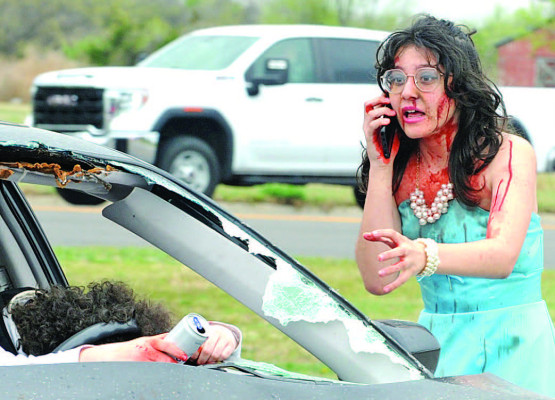 Mock accident Sage Rau makes a call to 911 during a mock accident, held last Thursday at Campus High School. CHS students were able to leave classes to witness the mock accident, which also served as a training session for local emergency responders. The accident showed the consequences of driving drunk, with one student actor in the scenario dying after being ejected from a vehicle. Another was arrested. See more photos on Page A6. Dale Stelz/TSnews