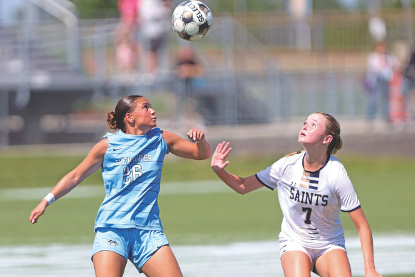 Eisenhower’s Kaitlyn Celso, left, tries to win a ball from the St. Thomas Aquinas Saints during Saturday’s Class 5A State soccer championship, which was played in Wichita.