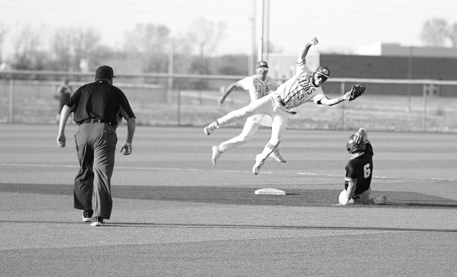 Goddard’s Taylor Cape catches a throw and successfully tags out Campus base runner Camden Stateler during last Friday’s game in Goddard. The Lions and the Colts each won a game in the doubleheader. Stephanie McKennon/TSnews