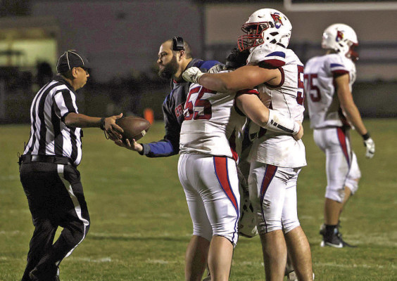 Cheney lineman Ayden Koehn wraps an arm around teammate Wyatt Starns (55) in consolation after the Cardinals lost at Rock Creek last Friday. For Starns, a senior, it was his final high school football game. Andrea McDaniel/TSnews