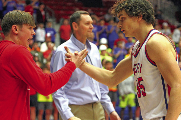 Cheney Cardinals starter Carter Peintner, right, is greeted by teammate Dietric McDaniel during introductions last Thursday at the Class 3A State basketball tournament. The Cardinas faced off against Goodland but lost the game, ending their season. Read more in Sports, Page B1. Travis Mounts/TSnews