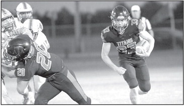 The Titans’ Dalton Morrison, right, follows the block of Carson Vineyard during last Friday’s football game in Argonia. Cheri Ricke/Contributed photo